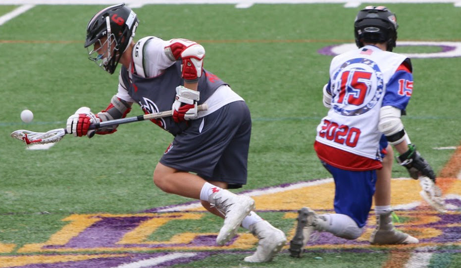 Two male lacrosse players seek possession of the ball during a lacrosse game.