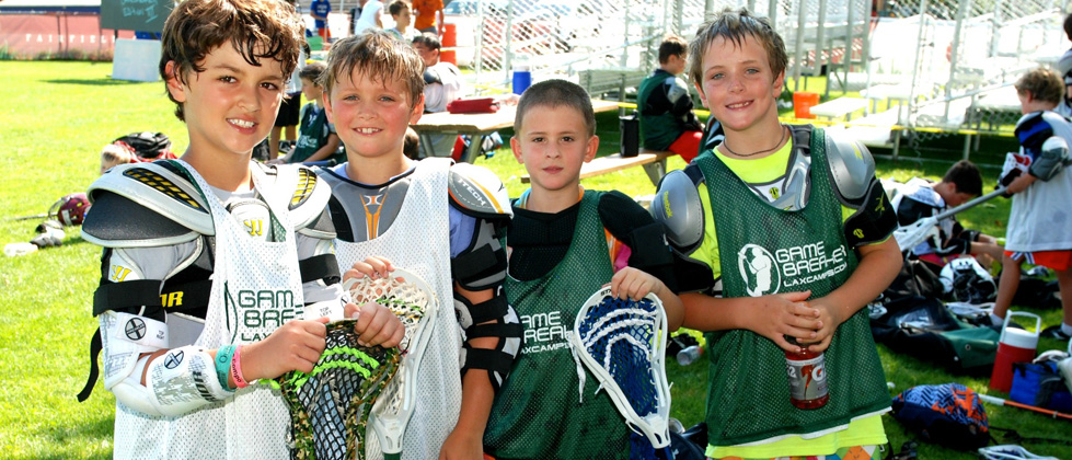 Boys smile during a break at their GameBreakers LAX Summer Camp.